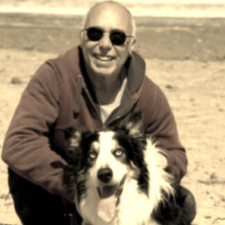 Suryacitta Suryacitta and his blind dog Bankei on the beach in the north of England